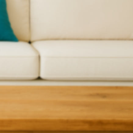 Living room background with grey sofa and wooden coffee table.
